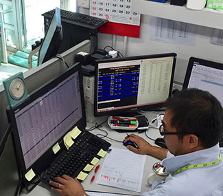a man in front of a computer working in the office