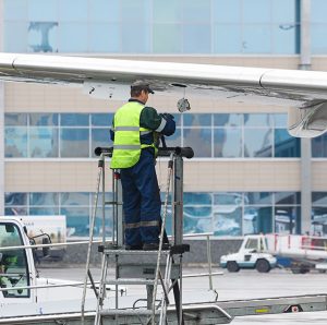 a man fueling an airplane